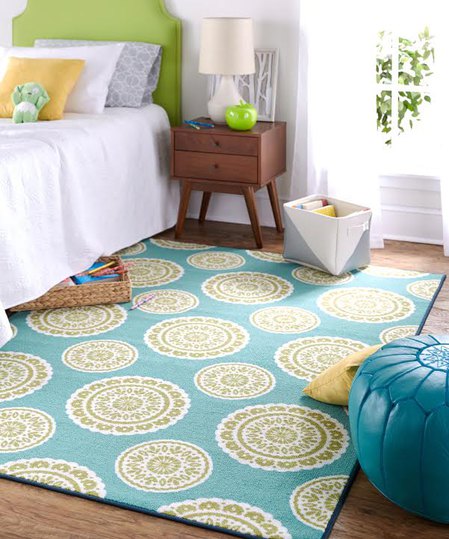 The bold headboard, apple accent and the floral medallions in the area rug tie the hottest hue of the year into this adorable kid's bedroom.