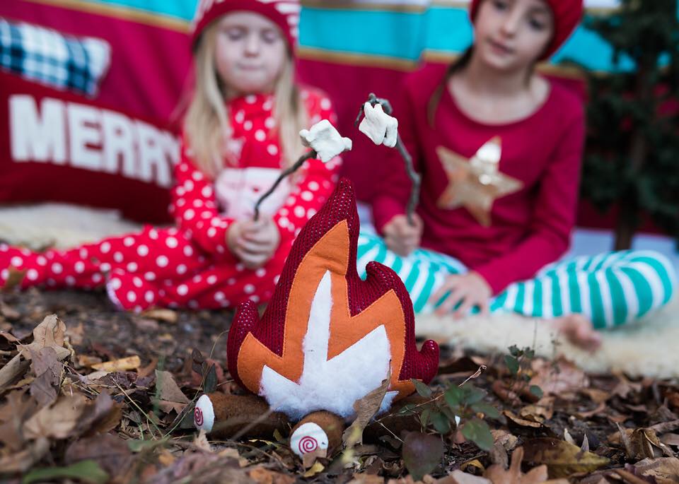 Sisters roasting marshmallows with toy campfire photo prop