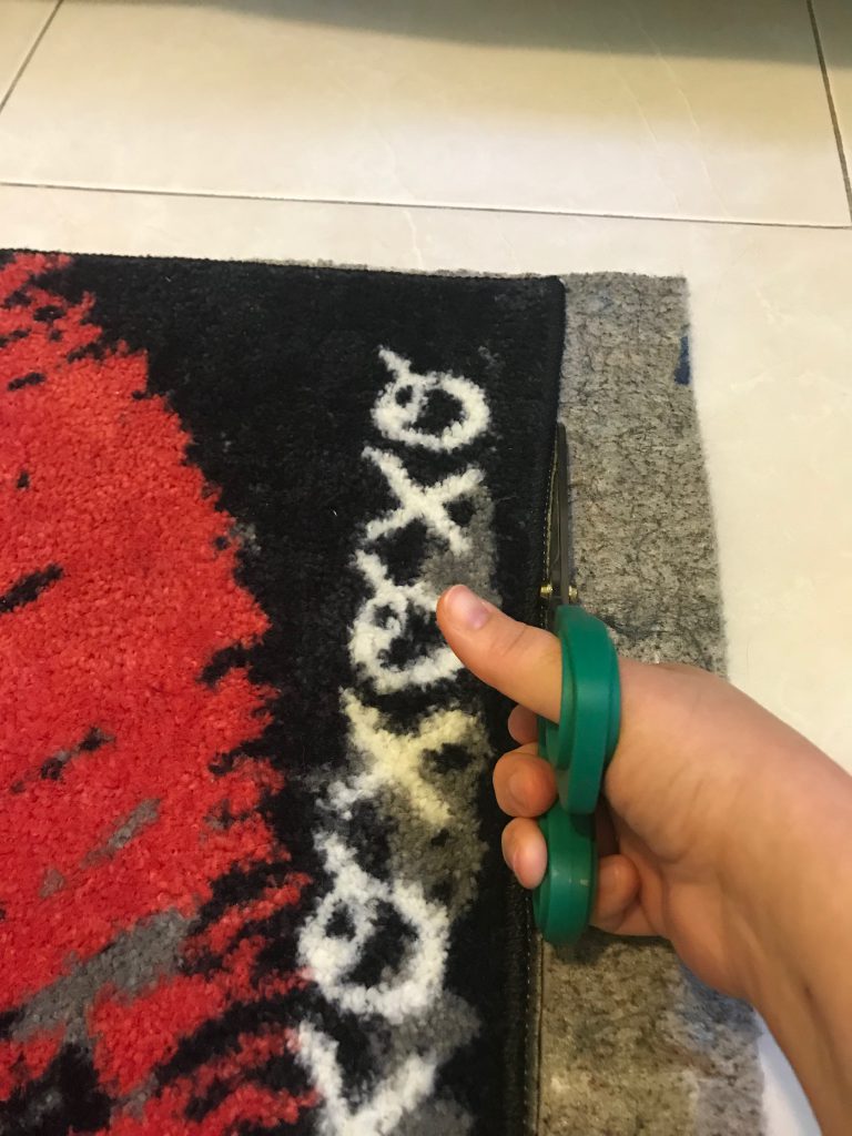 Mohawk Home area rug pad, trip vertically w/ fabric cutting scissors