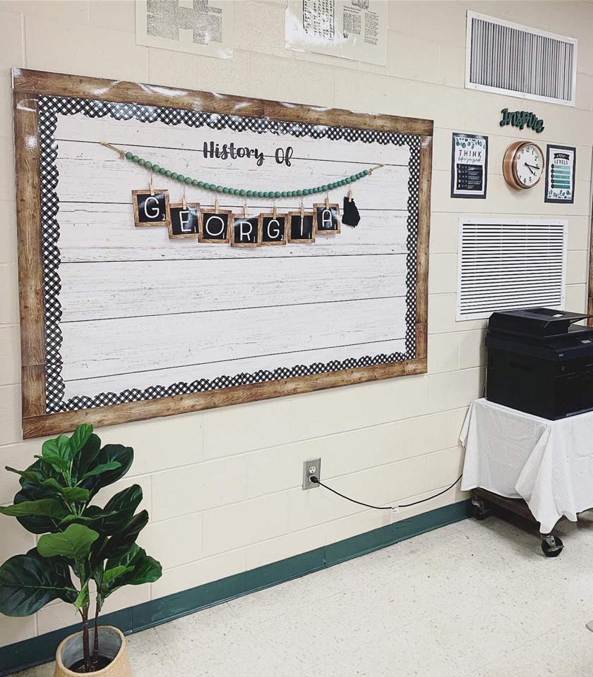 A 'History of Georgia' bulletin board with wood-look paper border and green wood beads make this farmhouse classroom complete.