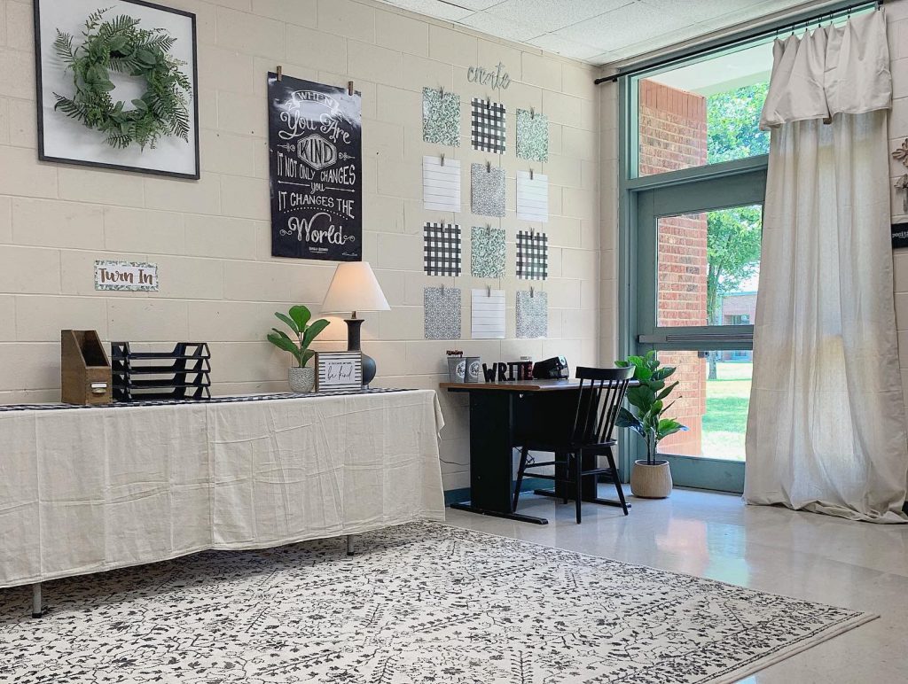 A rustic drop cloth table cover and drop cloth curtains add a touch of farmhouse style to this classroom.