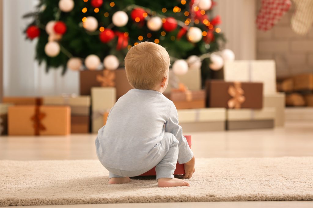 Baby looks at Christmas tree