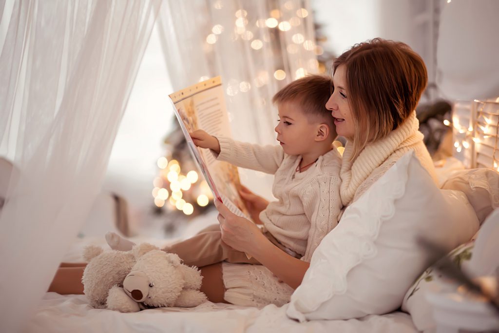 Mom reads a book to her son during the holidays