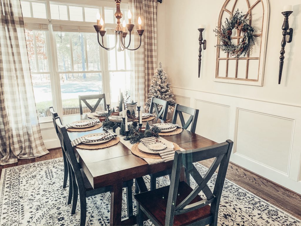 A picture containing a dining room table decorated for Christmas.
