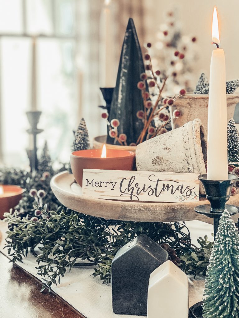 Merry Christmas tablescape featuring pine cones and seasonal decor