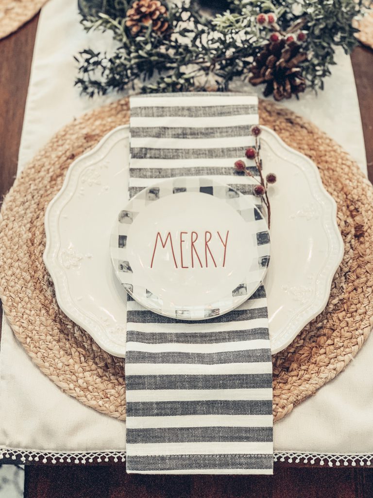 Holiday place setting with jute placemat and Merry sign
